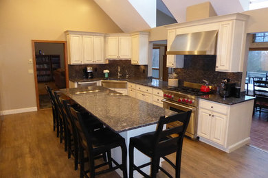 Kitchen - traditional kitchen idea in Bridgeport with a farmhouse sink, raised-panel cabinets, granite countertops and an island