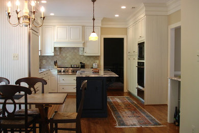 Eat-in kitchen - traditional l-shaped eat-in kitchen idea in DC Metro with raised-panel cabinets, white cabinets and beige backsplash