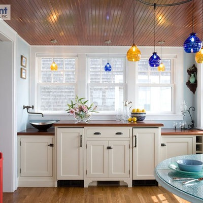 Inspiration for a coastal light wood floor eat-in kitchen remodel in Other with a single-bowl sink and white cabinets