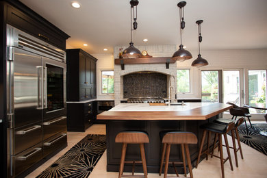 Example of a large classic l-shaped kitchen design in Chicago with an island
