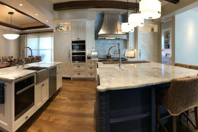 Eat-in kitchen - large modern galley dark wood floor, brown floor and coffered ceiling eat-in kitchen idea in Sacramento with a farmhouse sink, shaker cabinets, white cabinets, marble countertops, blue backsplash, marble backsplash, stainless steel appliances, two islands and white countertops
