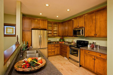 Example of a large mountain style l-shaped light wood floor eat-in kitchen design in Denver with a double-bowl sink, flat-panel cabinets, medium tone wood cabinets, stainless steel appliances and an island