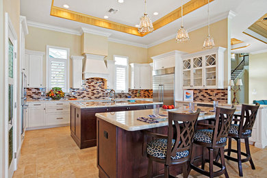 Inspiration for a large craftsman u-shaped eat-in kitchen remodel in Miami with recessed-panel cabinets, white cabinets, granite countertops and two islands