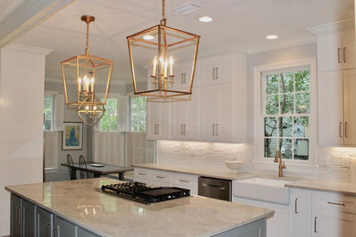 Large transitional single-wall ceramic tile and gray floor eat-in kitchen photo in Miami with a farmhouse sink, shaker cabinets, white cabinets, quartzite countertops, white backsplash, ceramic backsplash, stainless steel appliances, an island and gray countertops