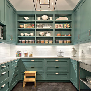 This is an example of a large country galley separate kitchen in Austin with open cabinets, white splashback, concrete floors, blue cabinets, marble benchtops, subway tile splashback, stainless steel appliances, with island, grey floor and white benchtop.