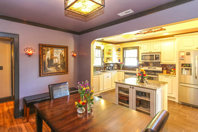 Mid-sized elegant kitchen photo in Charlotte with raised-panel cabinets and an island