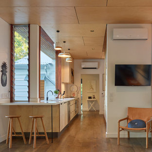Small contemporary galley kitchen in Brisbane with flat-panel cabinets, light wood cabinets, quartz benchtops, white splashback, stainless steel appliances, brown floor, white benchtop, an undermount sink, window splashback and medium hardwood floors.