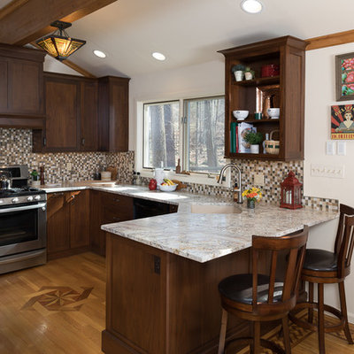 Small arts and crafts u-shaped medium tone wood floor enclosed kitchen photo in Philadelphia with an undermount sink, shaker cabinets, brown cabinets, granite countertops, multicolored backsplash, mosaic tile backsplash, paneled appliances and a peninsula