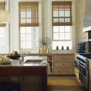 Inspiration for a mid-sized tropical l-shaped open plan kitchen in Miami with a double-bowl sink, beige cabinets, stainless steel appliances, with island, recessed-panel cabinets, granite benchtops and dark hardwood floors.