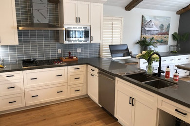 Inspiration for a mid-sized farmhouse u-shaped light wood floor eat-in kitchen remodel in San Luis Obispo with an undermount sink, shaker cabinets, white cabinets, quartz countertops, blue backsplash, ceramic backsplash, stainless steel appliances, a peninsula and gray countertops