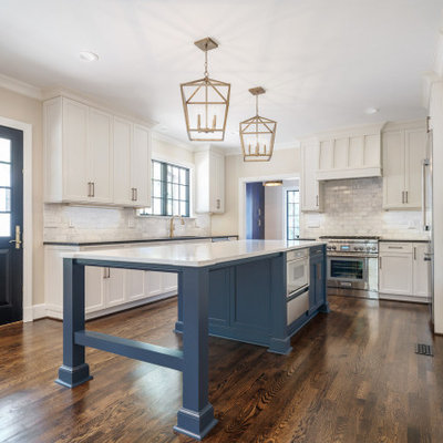 Inspiration for a large timeless galley dark wood floor and brown floor eat-in kitchen remodel in Other with a single-bowl sink, flat-panel cabinets, blue cabinets, quartz countertops, white backsplash, marble backsplash, stainless steel appliances, an island and white countertops