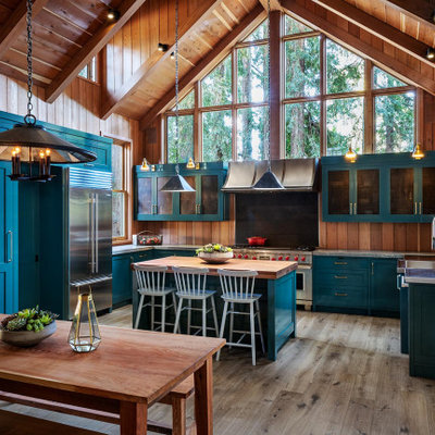 Large mountain style u-shaped medium tone wood floor and gray floor open concept kitchen photo in San Francisco with an integrated sink, shaker cabinets, blue cabinets, granite countertops, stainless steel appliances, an island and gray countertops