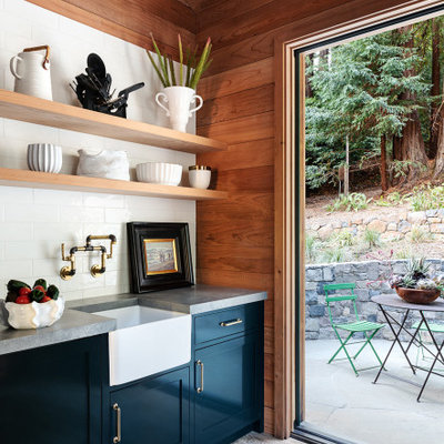 Open concept kitchen - large rustic u-shaped medium tone wood floor and gray floor open concept kitchen idea in San Francisco with an integrated sink, shaker cabinets, blue cabinets, granite countertops, stainless steel appliances, an island and gray countertops