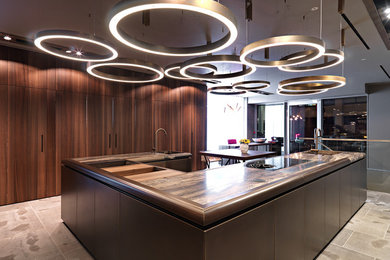 Large contemporary u-shaped open plan kitchen in London with flat-panel cabinets and marble worktops.