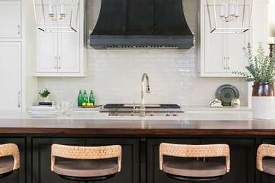 Mid-sized transitional medium tone wood floor and brown floor eat-in kitchen photo in Atlanta with a farmhouse sink, beaded inset cabinets, white cabinets, quartzite countertops, gray backsplash, ceramic backsplash, paneled appliances, an island and white countertops