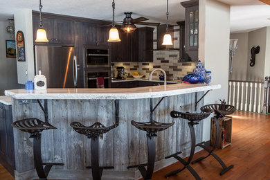 Eat-in kitchen - mid-sized country u-shaped eat-in kitchen idea in Calgary with a double-bowl sink, shaker cabinets, distressed cabinets, quartzite countertops, gray backsplash, slate backsplash, stainless steel appliances, a peninsula and white countertops