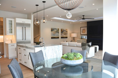 Eat-in kitchen - contemporary light wood floor eat-in kitchen idea in Salt Lake City with an undermount sink, glass-front cabinets, white cabinets, marble countertops, green backsplash, ceramic backsplash, stainless steel appliances and an island