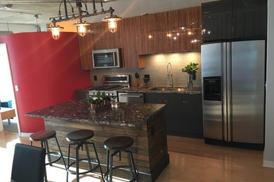 Mid-sized eclectic light wood floor eat-in kitchen photo in Detroit with an undermount sink, flat-panel cabinets, dark wood cabinets, gray backsplash, glass tile backsplash, stainless steel appliances and an island