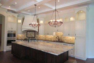 Large elegant single-wall kitchen photo in Miami with an undermount sink, quartzite countertops, beige backsplash, stainless steel appliances and an island