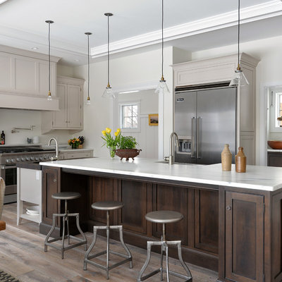Kitchen - mid-sized traditional medium tone wood floor kitchen idea in Portland Maine with beaded inset cabinets, marble countertops, stainless steel appliances and an island