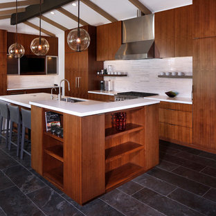 Design ideas for an expansive contemporary l-shaped eat-in kitchen in Los Angeles with an undermount sink, flat-panel cabinets, dark wood cabinets, quartz benchtops, white splashback, matchstick tile splashback, stainless steel appliances, marble floors, with island, blue floor and yellow benchtop.