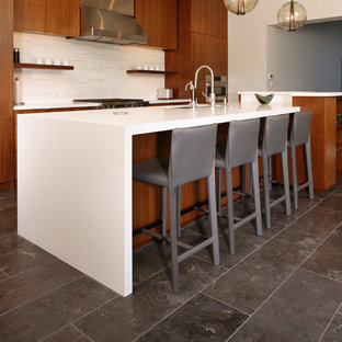 Inspiration for an expansive contemporary l-shaped eat-in kitchen in Los Angeles with an undermount sink, flat-panel cabinets, dark wood cabinets, quartz benchtops, white splashback, matchstick tile splashback, stainless steel appliances, marble floors, with island, blue floor and yellow benchtop.