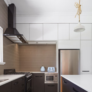 Design ideas for a contemporary kitchen in Perth with a drop-in sink, flat-panel cabinets, black cabinets, brown splashback, cement tile splashback, stainless steel appliances, with island, beige floor and white benchtop.
