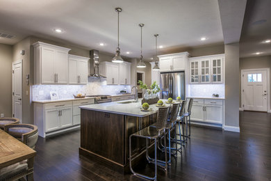 Eat-in kitchen - transitional dark wood floor and brown floor eat-in kitchen idea in Other with a single-bowl sink, recessed-panel cabinets, white cabinets, quartz countertops, white backsplash, ceramic backsplash, stainless steel appliances, an island and white countertops