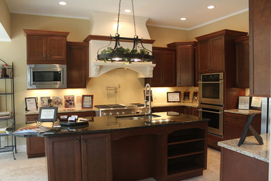 Example of an u-shaped ceramic tile eat-in kitchen design in Other with a double-bowl sink, shaker cabinets, medium tone wood cabinets, granite countertops, stainless steel appliances and an island