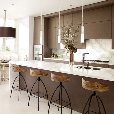 Trendy galley kitchen photo in San Francisco with an undermount sink, flat-panel cabinets, dark wood cabinets, marble countertops, white backsplash, stone slab backsplash, stainless steel appliances and white countertops