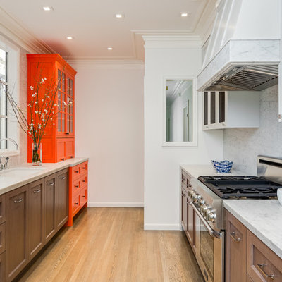 Enclosed kitchen - traditional galley beige floor enclosed kitchen idea in San Francisco with recessed-panel cabinets, dark wood cabinets, white backsplash and stone slab backsplash