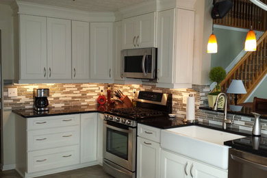 Traditional kitchen in Columbus with recessed-panel cabinets and white cabinets.