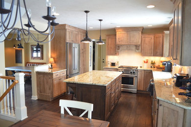 Mountain style l-shaped dark wood floor eat-in kitchen photo in Other with an undermount sink, shaker cabinets, medium tone wood cabinets, laminate countertops, black backsplash, subway tile backsplash, stainless steel appliances and two islands