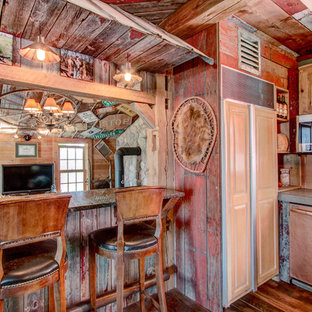 Photo of a small country galley eat-in kitchen in Milwaukee with a farmhouse sink, louvered cabinets, light wood cabinets, concrete benchtops, beige splashback, ceramic splashback, panelled appliances, medium hardwood floors and with island.