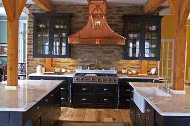 Large country single-wall open concept kitchen photo in Baltimore with a farmhouse sink, black cabinets and two islands