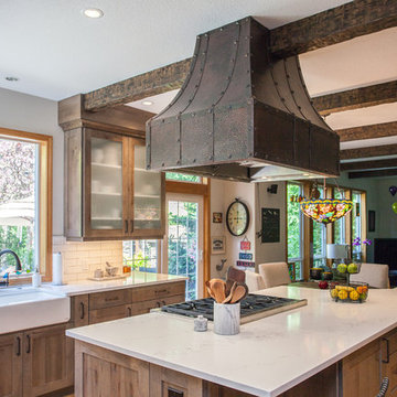 Rustic faux wood beams and custom hammered copper hood