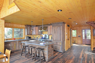 Inspiration for a mid-sized rustic l-shaped dark wood floor open concept kitchen remodel in Denver with an undermount sink, shaker cabinets, medium tone wood cabinets, paneled appliances and an island