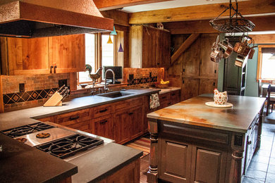 Photo of a large rustic l-shaped kitchen/diner in Milwaukee with a submerged sink, shaker cabinets, medium wood cabinets, concrete worktops, multi-coloured splashback, stainless steel appliances, slate flooring, an island, stone tiled splashback and grey floors.