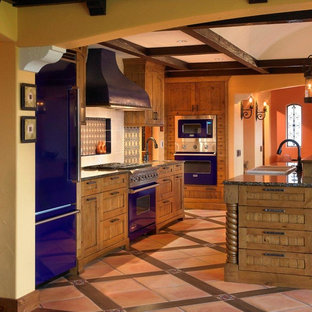 Inspiration for a mid-sized country galley eat-in kitchen in Phoenix with a drop-in sink, recessed-panel cabinets, medium wood cabinets, coloured appliances, multi-coloured floor, terra-cotta floors and granite benchtops.