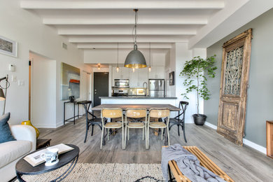 Eat-in kitchen - small rustic galley light wood floor eat-in kitchen idea in Toronto with an undermount sink, flat-panel cabinets, white cabinets, quartz countertops, gray backsplash, glass tile backsplash, stainless steel appliances and an island
