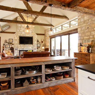 Example of a mountain style open concept kitchen design in Other with open cabinets and wood countertops