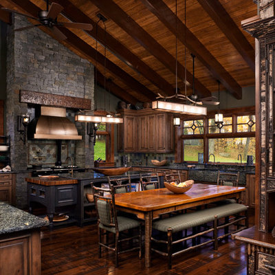 Example of a large mountain style u-shaped enclosed kitchen design in Other with raised-panel cabinets and medium tone wood cabinets