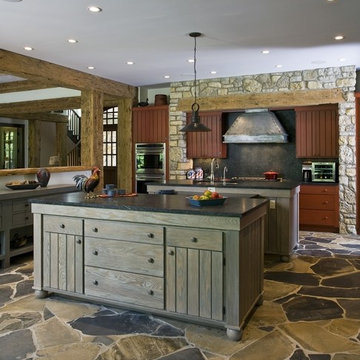 Rustic Kitchen Features Red and Grey Stained Cabinetry and Soapstone Countertops