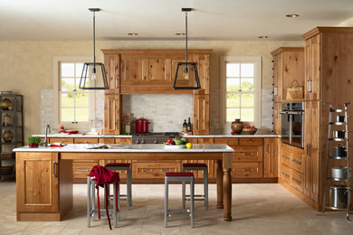 Example of a mountain style l-shaped eat-in kitchen design in Minneapolis with a drop-in sink, flat-panel cabinets, light wood cabinets, marble countertops, white backsplash, ceramic backsplash and stainless steel appliances