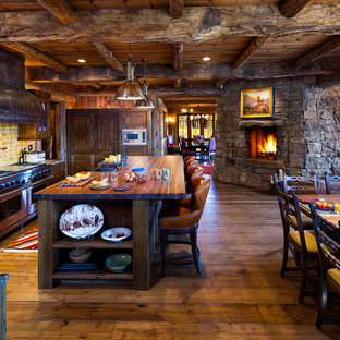 Diseño de cocina comedor en U, rural, con puertas de armario con efecto envejecido, encimera de madera y salpicadero beige