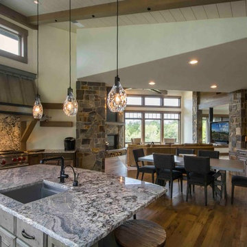 Rustic Kitchen Opens to Dining Room and Great Room with Stone Accent Walls