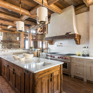 Rustic kitchen photos - Kitchen - rustic l-shaped dark wood floor kitchen idea in Other with recessed-panel cabinets, gray cabinets, white backsplash, stainless steel appliances and an island