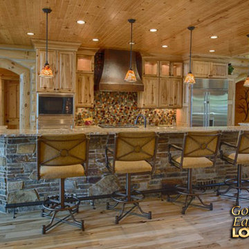 Rustic kitchen stone covered raised snack bar Golden Eagle log home