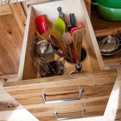 Inspiration for a mid-sized rustic l-shaped light wood floor eat-in kitchen remodel in Indianapolis with a single-bowl sink, flat-panel cabinets, medium tone wood cabinets, quartzite countertops, white backsplash, subway tile backsplash, paneled appliances and an island