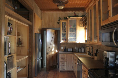 Rustic kitchen in Omaha with glass-front cabinets.